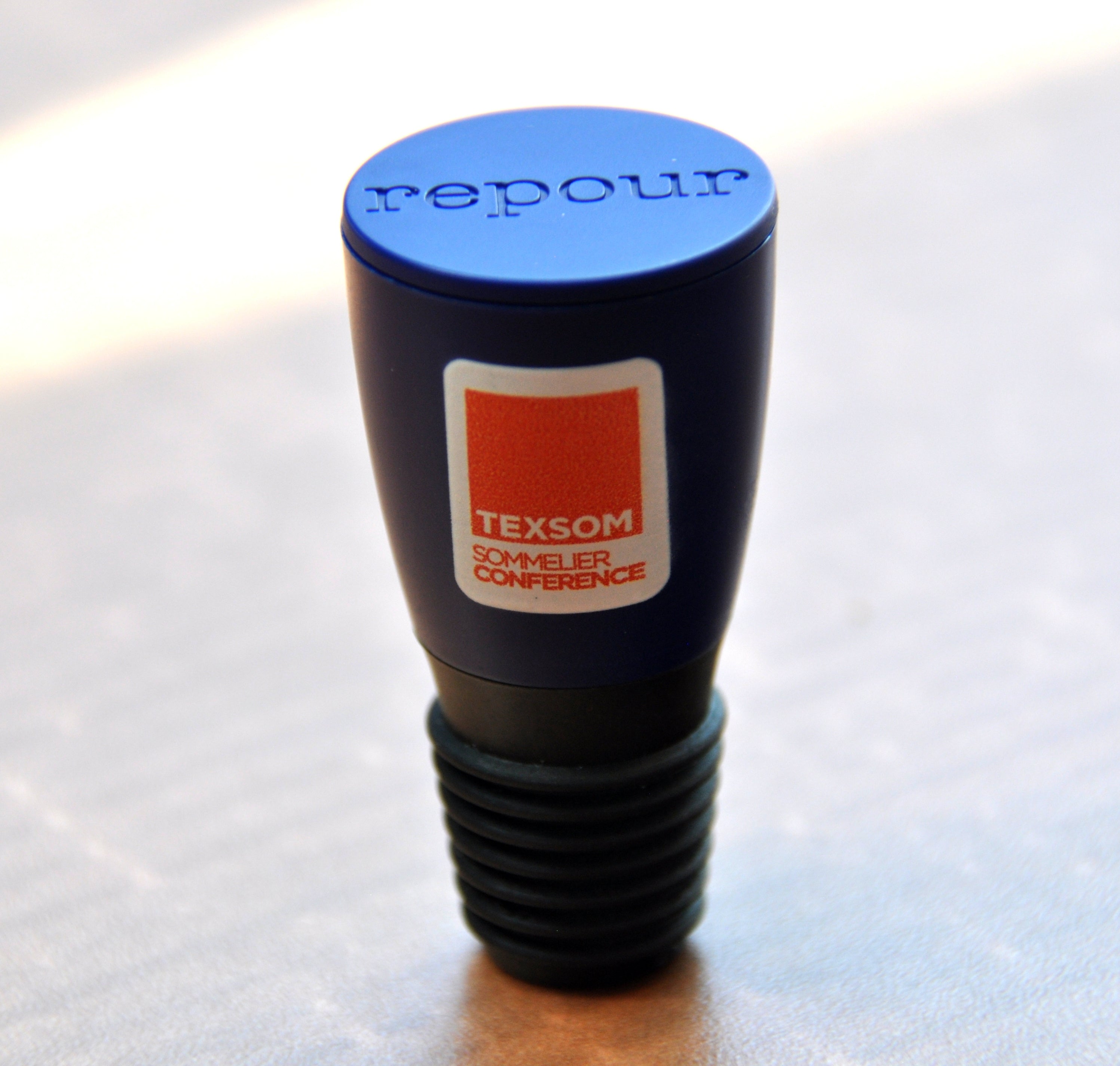 Custom branded Repour Wine Saver Stoppers Shown with TEXSOM logo